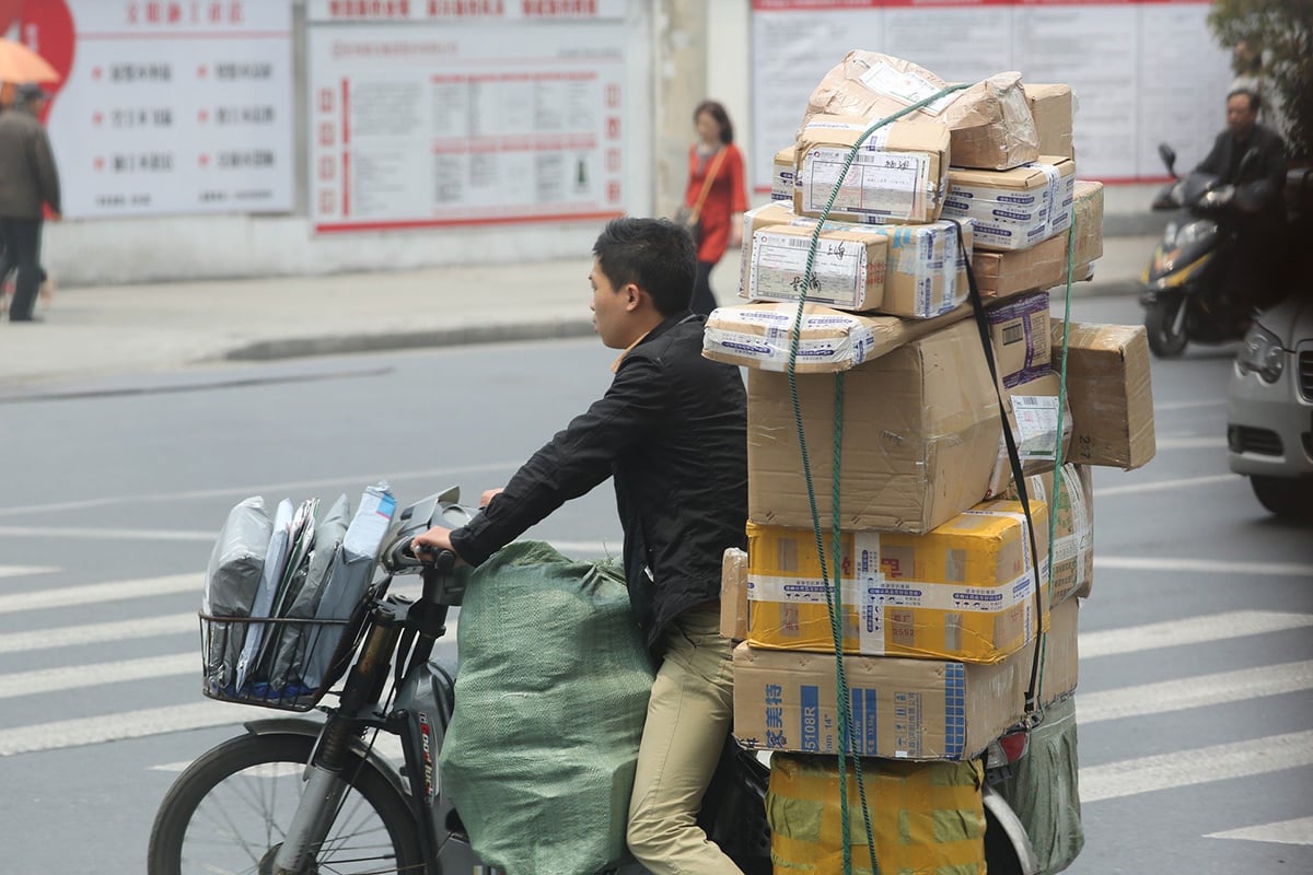 Man on bike with parcels_1200.jpg